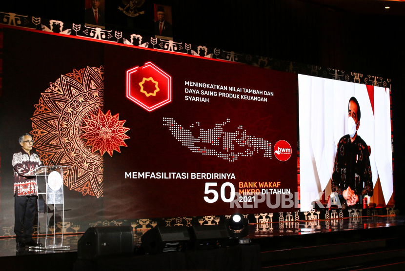 Ketua Dewan Komisioner OJK Wimboh Santoso (kiri) memberikan sambutan yang disaksikan secara virtual oleh Presiden Joko Widodo (kanan) saat pertemuan tahunan OJK di Jakarta, Jumat (15/1/2021). OJK sudah menyiapkan berbagai kebijakan stimulus lanjutan untuk tetap menjaga industri jasa keuangan dan meningkatkan kontribusinya dalam mendorong serta memulihkan perekonomian nasional yang termuat dalam Masterplan Sektor Jasa Keuangan Indonesia (MPSJKI) 2021 – 2025. 