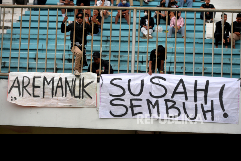 Spanduk terkait Tragedi Kanjuruhan dibentangkan suporter saat laga PSS Sleman melawan Arema FC pada lanjutan Liga 1 di Stadion Maguwoharjo, Yogyakarta, belum lama ini.