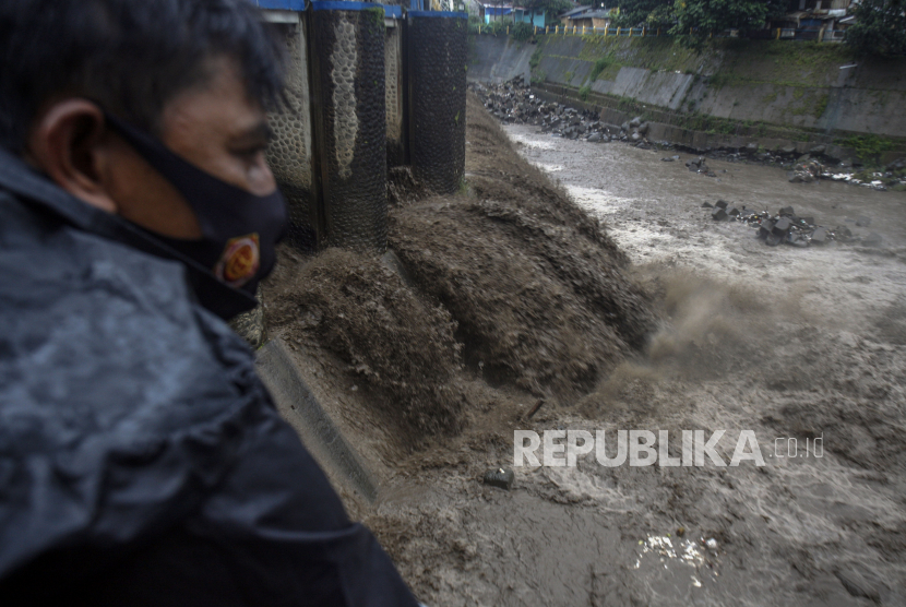 Warga mengamati aliran sungai Ciliwung yang keruh di Bendungan Katulampa ,Kota Bogor, Jawa Barat (ilustrasi) Selasa (19/1/2021). Kondisi air sungai Ciliwung menghitam karena bercampur dengan material bekas longsor dan banjir di kawasan Puncak. 