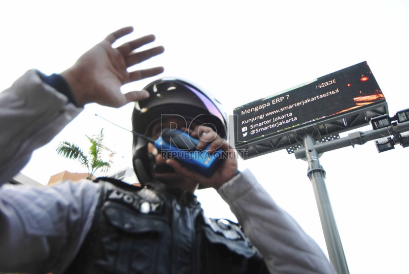  (Ilustrasi) Petugas dinas perhubungan mengatur kendaraan yang melintas saat  uji coba mesin electronic road pricing (ERP) di Jalan H.R. Rasuna Said, Kuningan, Jakarta Selatan, Selasa (30/9). (Republika/Rakhmawaty La'lang)  
