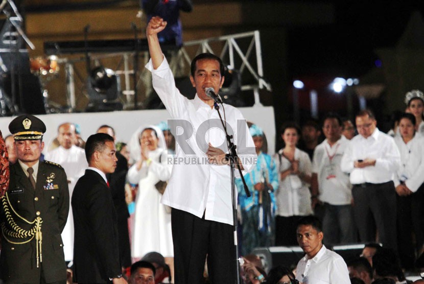   Presiden Jokowi menyapa para pendukungnya pada Konser Salam 3 Jari di lapangan Monumen Nasional, Jakarta, Senin (20/10) malam.   (Republika/Yasin Habibi)
