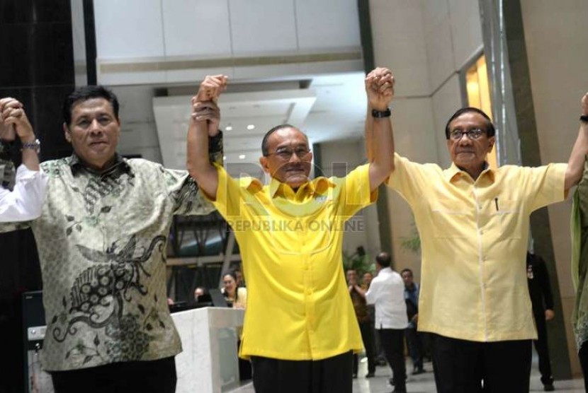  Ketua Umum Partai Golkar Aburizal Bakrie (tengah) bersama jajaran pengurus partai mengangkat tangan bersama usai menggelar konferensi pers terkait penyenggelaraan Munas ke-7 Partai Golkar di Jakarta, Selasa (25/11) malam.  (Republika/Wihdan)