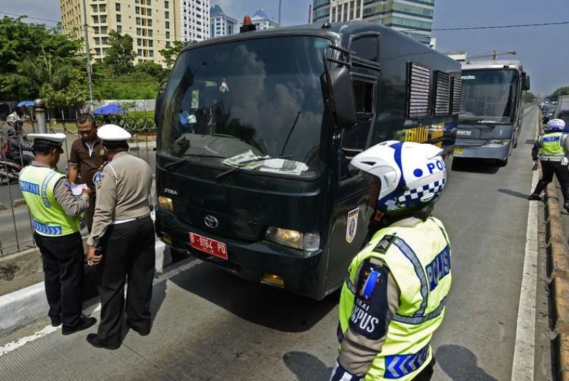  Polisi memberi surat tilang pada kendaraan pelat merah yang masuk ke jalur busway saat Operasi Zebra Jaya 2014 di kawasan Terminal Senen, Jakarta Pusat, Rabu (26/11).   (Antara/Fanny Octavianus)