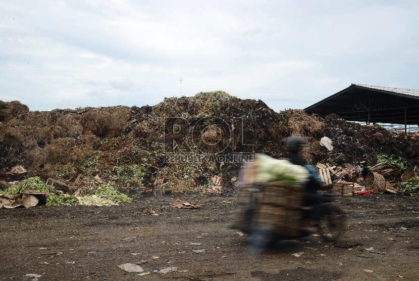  Warga melintas di samping sampah yang menggunung di Pasar Kramat Jati, Jakarta Timur, Kamis (8/1).  (Republika/Raisan Al Farisi)