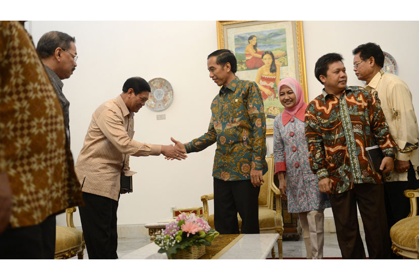  Presiden Joko Widodo (ketiga kiri) berjabat tangan dengan Menko Polhukam Tedjo Edy Purdjiatno disaksikan Anggota Kompolnas lainnya  di Istana Merdeka, Jakarta, Kamis (29/1). (Antara/Prasetyo Utomo)