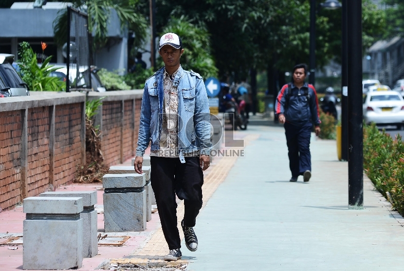 Pengguna jalan menggunakan jalur pedestrian di Jalan Rasuna Said, Jakarta Selatan, Jumat (30/1).  (Republika/Raisan Al Farisi)