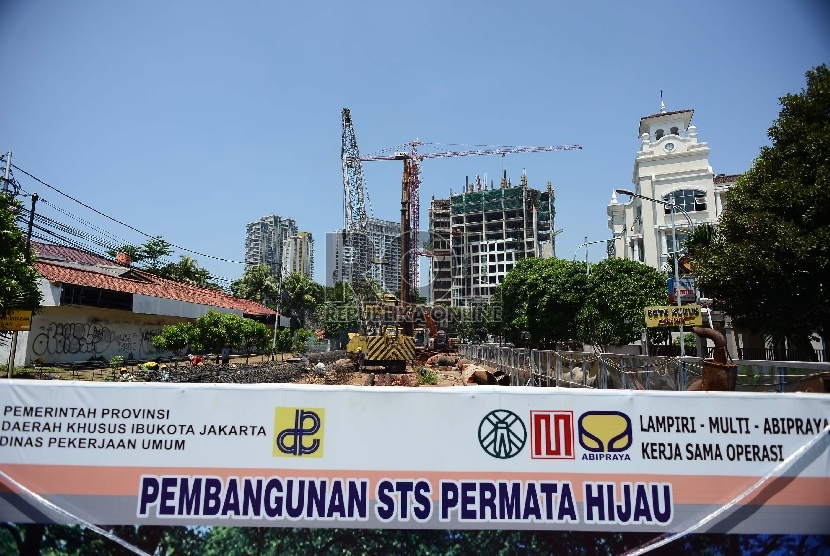 Pekerja bersama alat berat mengangkat besi beton di proyek pembangunan jalan layang Simpang Tak Sebidang (STS) Permata Hijau di kawasan Patal Senayan, Jakarta Selatan, Ahad (22/2). (Republika/Raisan Al Farisi)