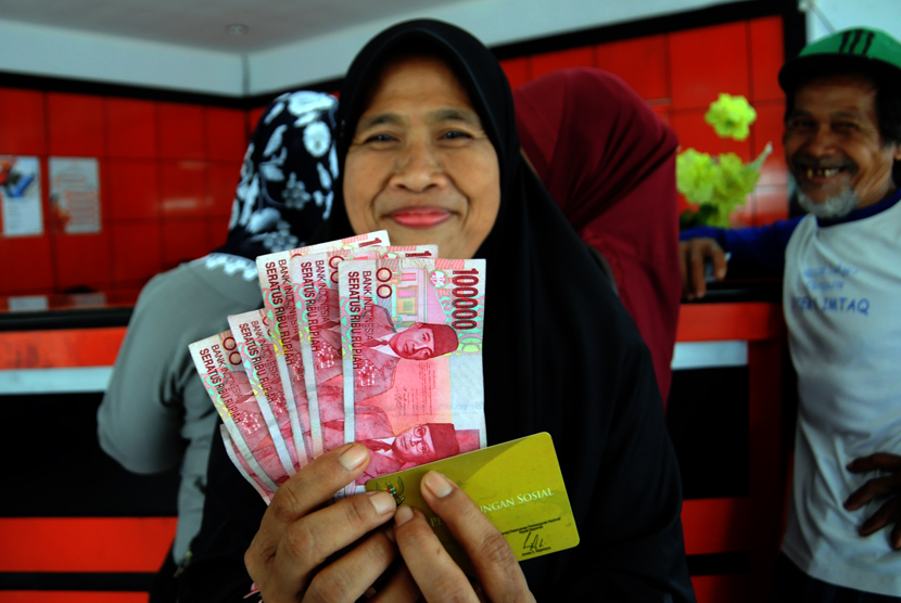  Seorang warga tersenyum usai mendapatkan dana Program Simpanan Keluarga Sejahtera (PSKS) di kantor POS Jalan Rambutan, Depok, Selasa (14/4). (foto : MgROL_34)