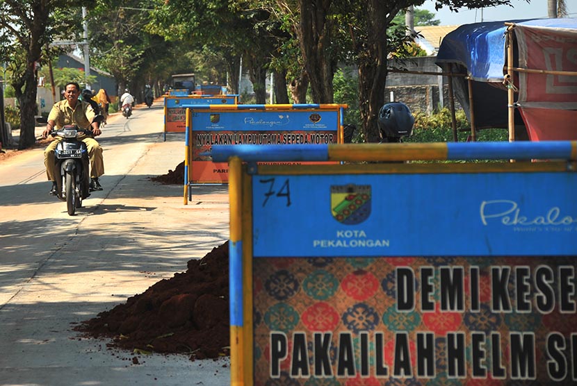   Pengendara sepeda motor melintas di jalur alternatif arus mudik yang tengah diperbaiki di kawasan Jalan Ki Mangun Sarkoro, Pekalongan, Jawa Tengah, Senin (22/6). (Antara/Pradita Utama)