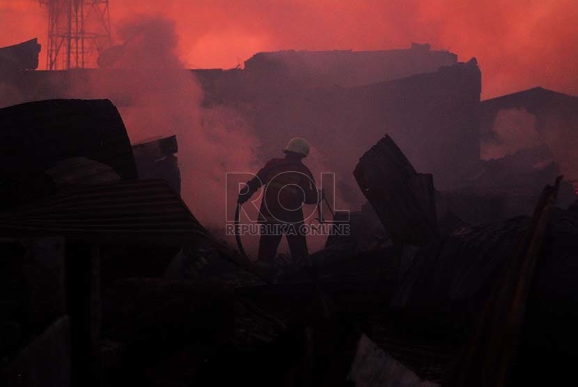  Petugas pemadam kebakaran menyisir lokasi pasar Gedebage yang sudah terbakar, Kota Bandung, Senin (20/7). (foto : Septianjar Muharam)
