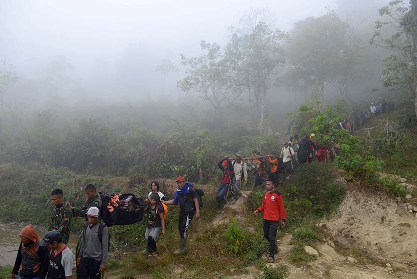  Tim gabungan Basarnas, TNI, Polri dan warga lokal mengevakuasi korban pesawat Aviastar DHC6/PK-BRM Dusun Gamaru, Desa Ulu Salu, Kecamatan Latimojong, Kabupaten Luwu, Sulawesi Selatan, Selasa (5/10).  (Antara/Sahrul Manda Tikupadang)