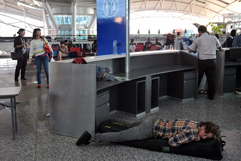  Seorang warga negara asing tertidur saat menunggu jadwal penerbangannya di Terminal Internasional Bandara Ngurah Rai, Denpasar, Rabu (4/11). (Antara/Nyoman Budhiana)