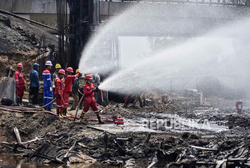 Petugas dari Pertamina melakukan penyemprotan di area pipa bahan bakar minyak milik Pertamina yang terbakar di Kelurahan Melong, Kota Cimahi, Rabu (23/10).