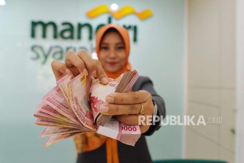 Teller menghitung uang di Bank Syariah Mandiri (Mandiri Syariah) Kantor Cabang Mayestik, Jakarta, Rabu (30/10). Mandiri Syariah membukukan laba bersih sebesar Rp 1,28 triliun per Desember 2019, naik 110,68 persen dibanding periode yang sama tahun lalu.