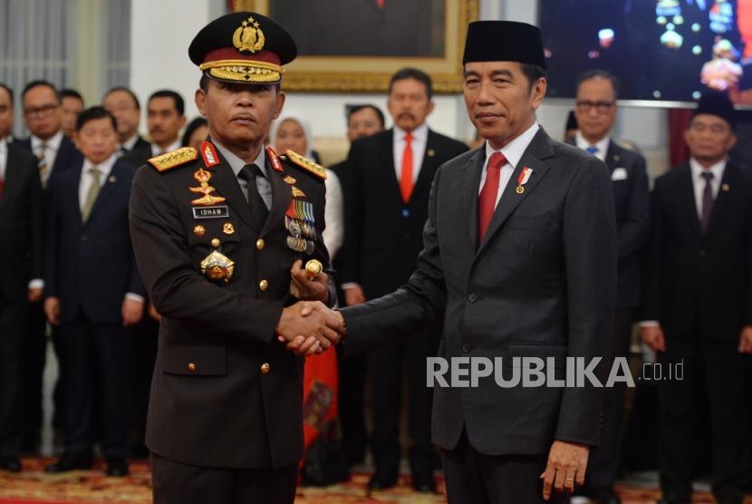 Presiden Joko Widodo berjabat tangan dengan Kapolri Jendral Idham Aziz saat pelantikan Kapolri di Istana Merdeka, Jakarta, Jumat (1/10).