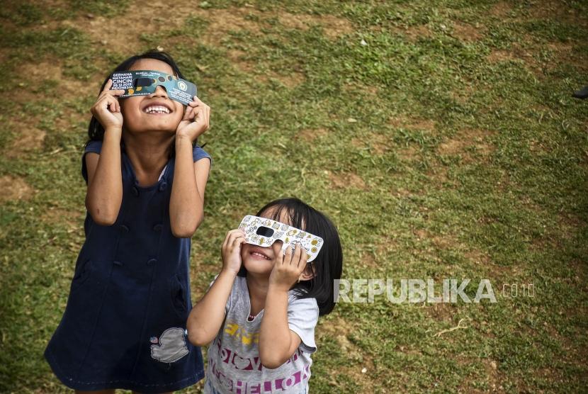 Sejumlah anak mencoba kacamata untuk melihat gerhana matahari cincin di Imah Noong, Kecamatan Lembang, Kabupaten Bandung Barat, Rabu (27/11).