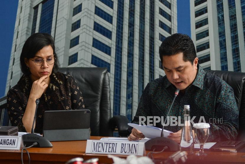 Menteri Badan Usaha Milik Negara (BUMN) Erick Thohir (kanan) bersma Menteri Keuangan Sri Mulyani (kiri) saat konferensi pers di Gedung Kementerian Keuangan, Jakarta, Kamis (5/12).