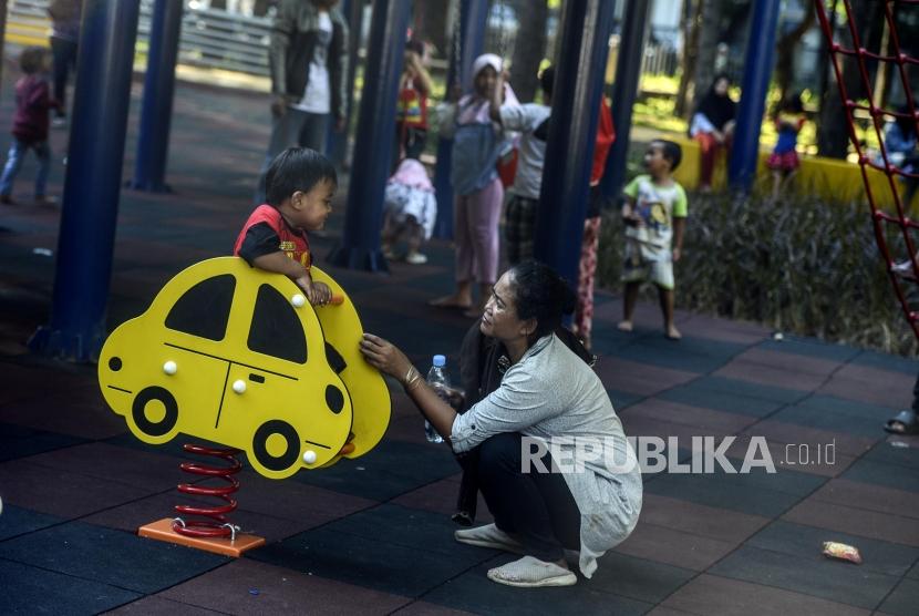 <em>Akhlaq Lil Banin</em>: Adab Anak pada Ibu. Seorang ibu menemani anaknya bermain di Taman Puring, Kebayoran Baru, Jakarta.