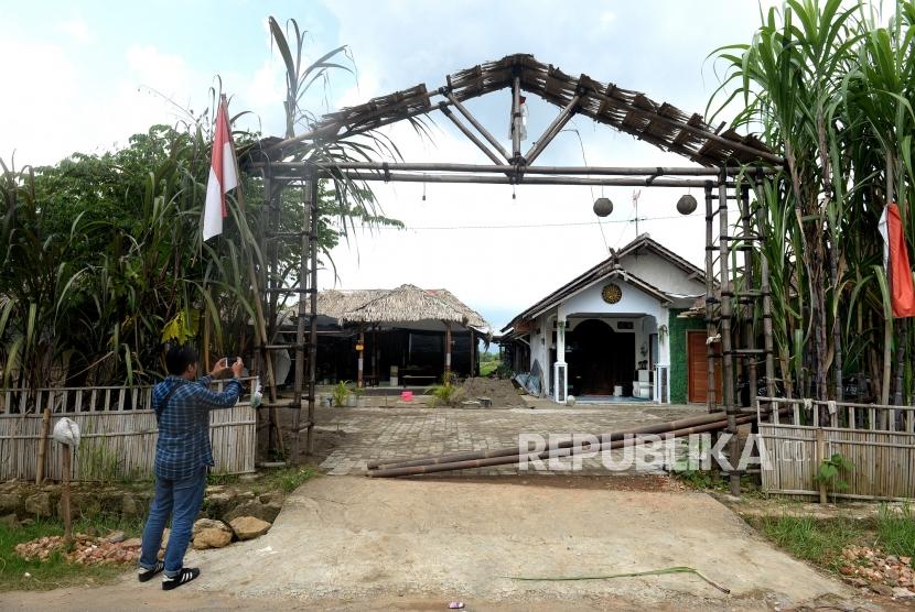 Sejumlah pengunjung berada di gapura pintu masuk komplek Keraton Agung Sejagad Desa Pogung Jurutengah, Bayan, Purworejo, Jawa Tengah, Selasa (14/1/2020).