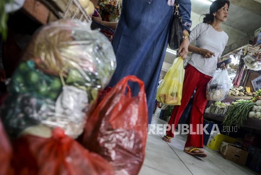 Pembeli membawa belanjaannya di dalam kantong plastik di Pasar Tebet Barat, Jakarta