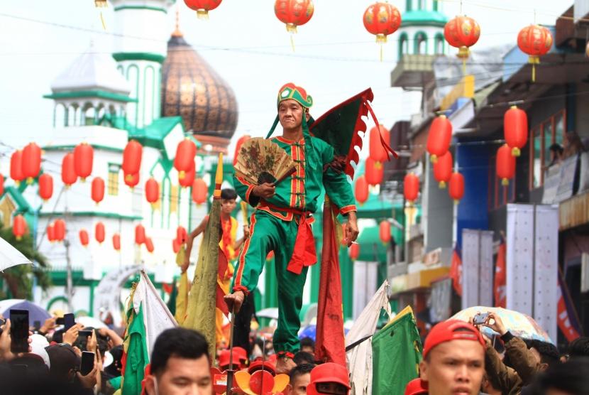 Seorang tatung (dukun Tionghoa yang kerasukan arwah leluhur) beratraksi saat mengikuti pawai perayaan Cap Go Meh di Kota Singkawang, Kalimantan Barat, Sabtu (8/2/2020).