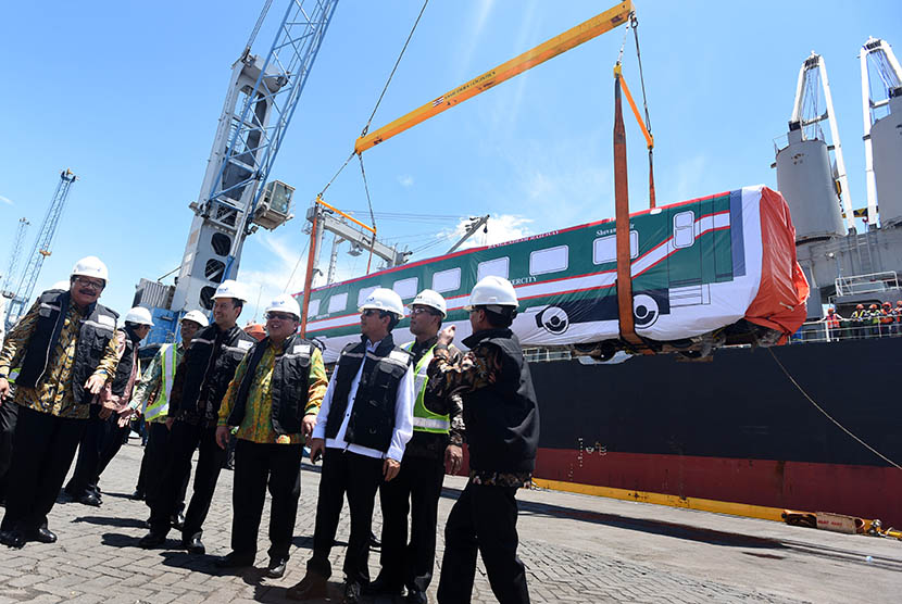  Sejumlah menteri dan Gubernur Jatim Soekarwo menyaksikan proses pemuatan gerbong kereta api ke dalam kapal saat ekspor perdana ke Bangladesh di Pelabuhan Tanjung Perak, Surabaya, Jawa Timur, Kamis (31/3). (Antara/Zabur Karuru)