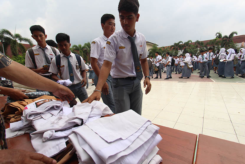 Sejumlah pelajar SMA menyumbangkan baju seragam sekolah mereka seusai pelaksanaan Ujian Nasional Berbasis Komputer (UNBK) hari terakhiir. Ilustrasi
