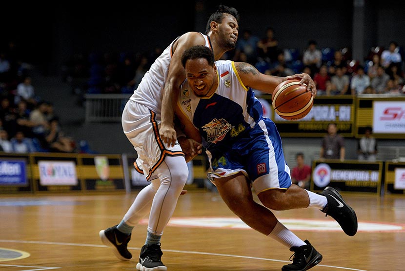 Pebasket Satria Muda Pertamina Dior Alexandros Lowhorn (kanan) menggiring bola dengan dihadang pebasket Pelita Jaya Adhi Pratama Prasetyo Putra dalam final kejuaraan Perbasi Cup di Britama Arena, Jakarta, Jumat (10/11) malam. 