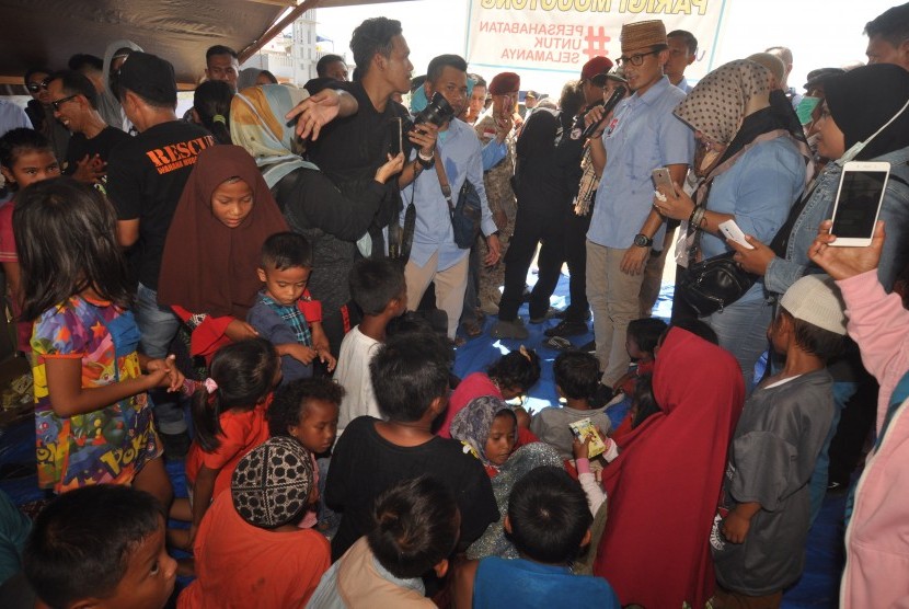 Calon Wakil Presiden nomor urut 02, Sandiaga Salahudin Uno menyapa para pengungsi saat berkunjung ke lokasi pengungsian korban gempa dan pencairan tanah (likuifaksi) di Palu, Sulawesi Tengah, Jumat (2/11/2018).