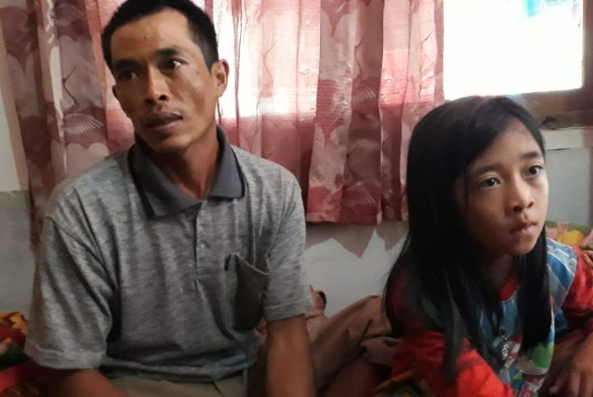 Seorang korban selamat akibat longsor di Desa Sirna Resmi Kecamatan Cisolok Kabupaten Sukabumi Tandi (32) dan anaknya Sindi (8) ditemui di rumah kerabatnya Rabu (2/1). Tandi kehilangan sebanyak 14 anggota keluarga.