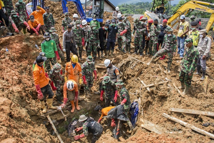 Petugas SAR gabungan bergotong royong berusaha mengeluarkan jenazah korban longsor yang tertimbun material tanah di Desa Sirnaresmi, Cisolok, Kabupaten Sukabumi, Jawa Barat, Sabtu (5/1/2019).