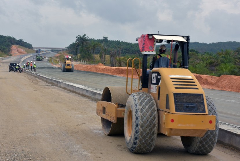 Sejumlah pekerja menyelesaikan pekerjaan pembangunan jalan tol Pekanbaru-Dumai Seksi 1 di Provinsi Riau, Rabu (30/1/2019).