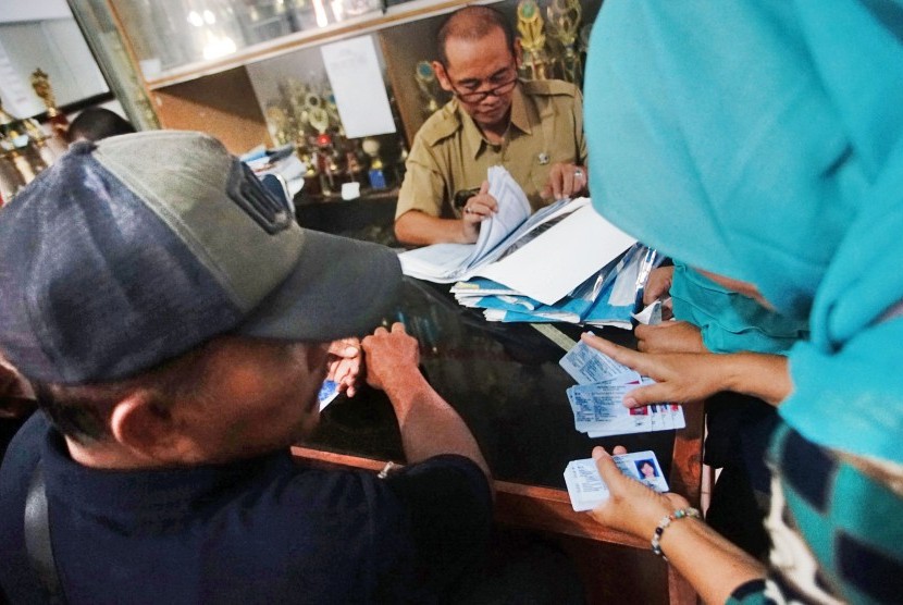 Petugas Kelurahan melayani warga saat pengambilan KTP-el di Kelurahan Bakti Jaya Depok, Jawa Barat, Senin (4/2/2019).