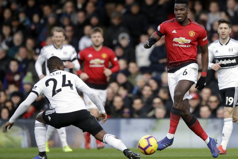 Striker Manchester United, Paul Pogba (kanan), diadang  Fulham Michael Seri pada  laga Liga Inggris di stadion Craven Cottage, London, Sabtu.