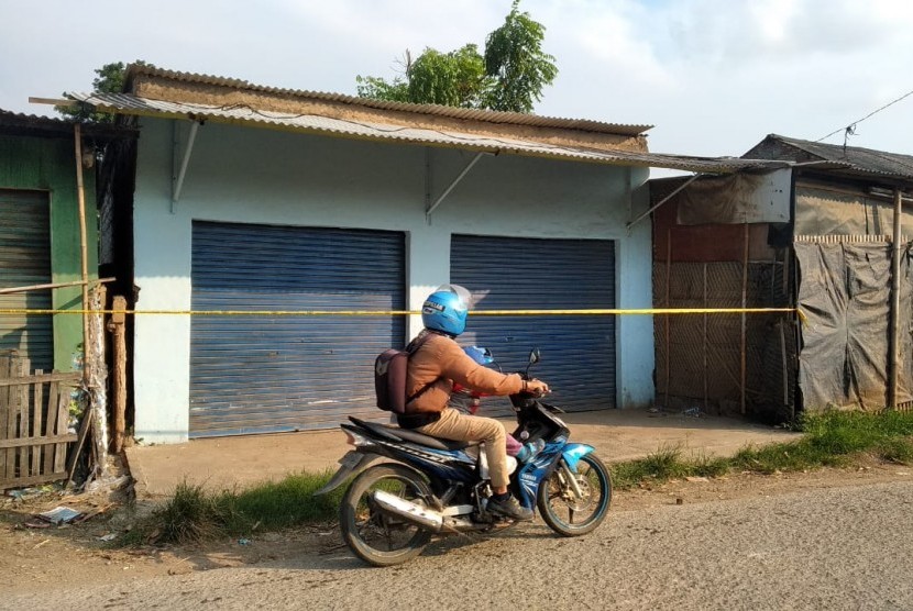 Seorang pengendara sedang melintas di depan lokasi penggerebekan terduga teroris di RT 11 RW 04, Desa Kedung Pengawas, Babelan, Kabupaten Bekasi, Sabtu (4/5). Penggerebekan oleh Tim Densus 88 pada pukul 04.00 WIB itu mengakibatkan 1 orang terduga teroris tewas ditempat.