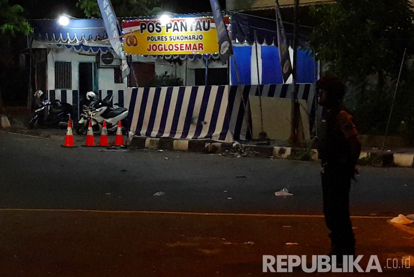 Seorang anggota kepolisian menjaga lokasi kejadian ledakan di Pos Pantau Arus Mudik Joglosemar, Kartasura, Sukoharjo, Jawa Tengah, Selasa (4/6/2019). 
