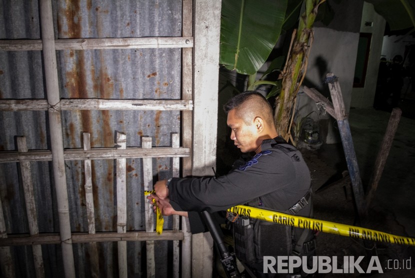 Polisi memasang garis polisi saat penggeledahan rumah pelaku peledakan Pospam Kartasura di dusun Kranggan, Wirogunan, Kartasura, Sukoharjo, Jawa Tengah, Selasa (4/6/2019) dini hari. 