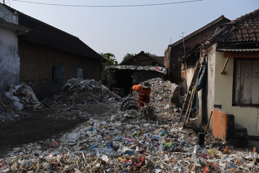 Warga memilah tumpukan sampah plastik impor di halaman rumahnya di Desa Bangun di Mojokerto, Jawa Timur, Rabu (19/6/2019). 