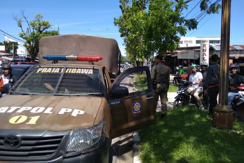 Satpol PP Kota Padang amankan sejumlah titik tempat putar arah di jalanan Kota Padang untuk mengantisipasi keberadaan pak ogah atau polisi cepek, Rabu (26/6). 