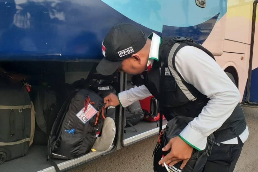 Seorang petugas haji memasukkan tas ke bus yang akan memberangkatkan mereka dari Asrama Haji Pondok Gede Jakarta ke Bandara Internasional Soekarno-Hatta, Kamis (9/7). Mereka akan diberangkatkan ke Jeddah, Arab Saudi dan ditugaskan di Daerah Kerja Makkah. 