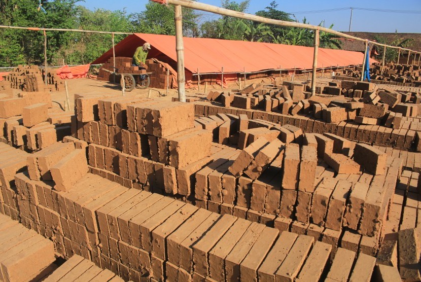 Pekerja menyelesaikan pembuatan batu bata merah. Produksi bata merah di Kudus terkendala bahan baku.