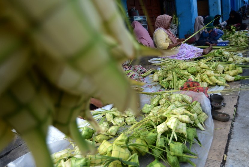 Warga membuat kulit ketupat dari daun kelapa untuk dijual di Pasar Tradisional Peunayung, Banda Aceh, Aceh, Jumat (9/8/2019).