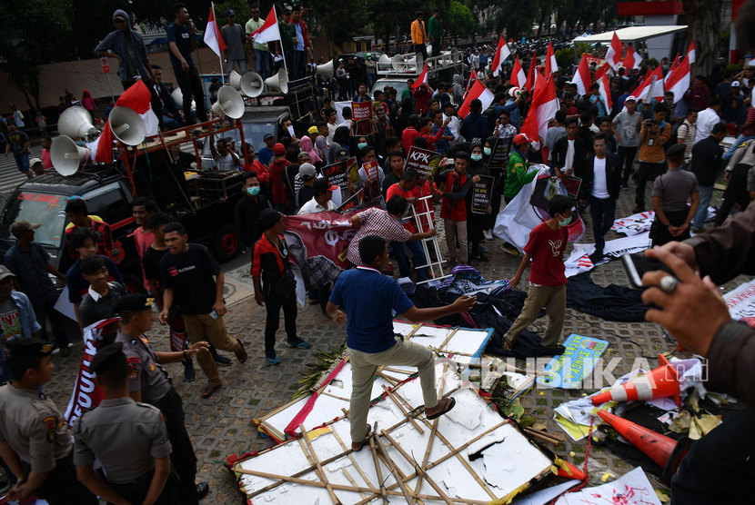 Massa dari Aliansi Mahasiswa dan Pemuda Relawan Cinta NKRI merusak karangan bunga saat unjuk rasa yang berakhir ricuh di kantor KPK, Jakarta, Jumat (13/9/2019).