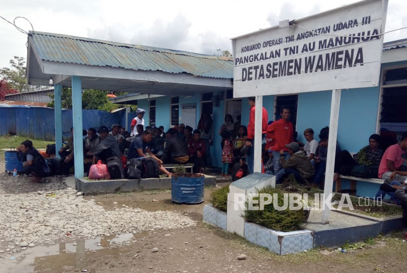 Warga menunggu pesawat Hercules milik TNI AU di Pangkalan TNI AU Manuhua Wamena, Jayawijaya, Papua, Rabu (25/9/2019).