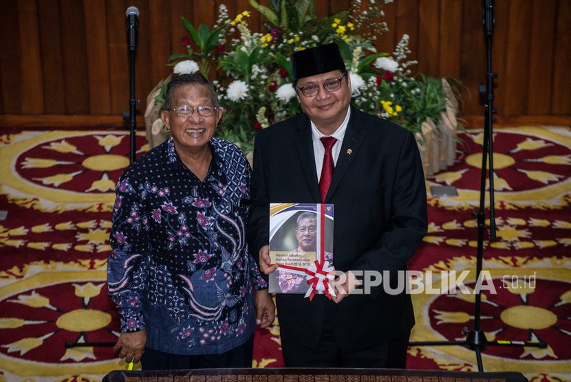 Menko Perekonomian Airlangga Hartarto (kanan) menerima buku memori jabatan Menko Perkonomian dari pejabat lama Darmin Nasution, dalam serah terima jabatan di Kantor Kemenko Perekonomian, Jakarta, Rabu (23/10/2019).