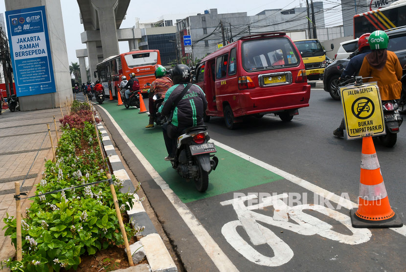 Pengendara sepeda motor melintasi jalur sepeda di Jalan Fatmawati, Jakarta, Kamis (31/10/2019). 