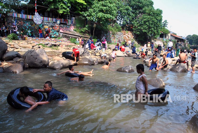 Sejumlah warga dan anak-anak bermain air di area sungai Ciliwung, Kampung Lebak Kantin, Kelurahan Sempur, Kota Bogor, Jawa Barat, Ahad (17/11/2019). 