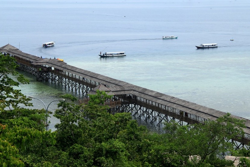 Sejumlah kapal pengangkut wisata melintas di dekat dermaga Pulau Karampuang, Mamuju, Sulawesi Barat, Ahad (24/11/2019). 