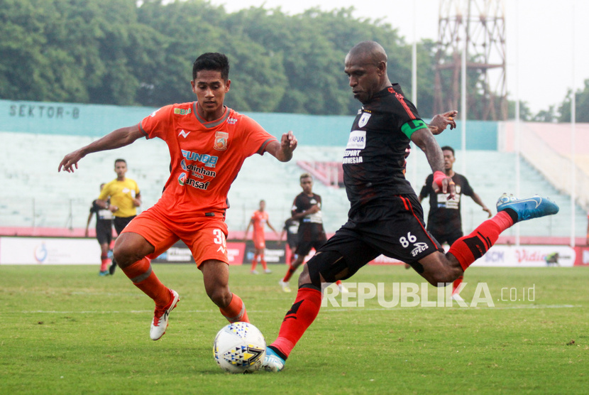 Pesepak bola Persipura Boaz Saolossa (kanan) dikawal pesepak bola Borneo FC Muhammad Ikhsan (kiri) pada lanjutan Liga 1 2019 di Stadion Gelora Delta Sidoarjo, Jawa Timur, Ahad (22/12/2019).