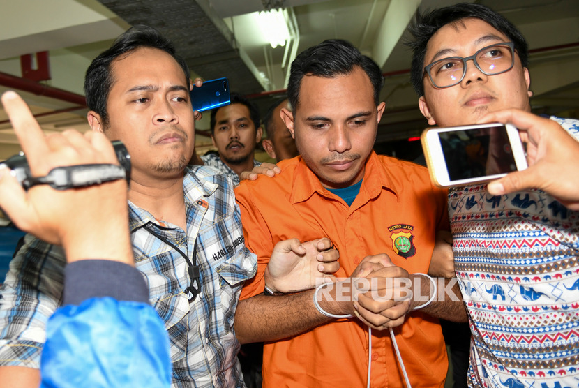 Pelaku penyiraman air keras terhadap Penyidik KPK Novel Baswedan dibawa petugas saat tiba di Bareskrim Mabes Polri di Jakarta, Sabtu (28/12/2019). 